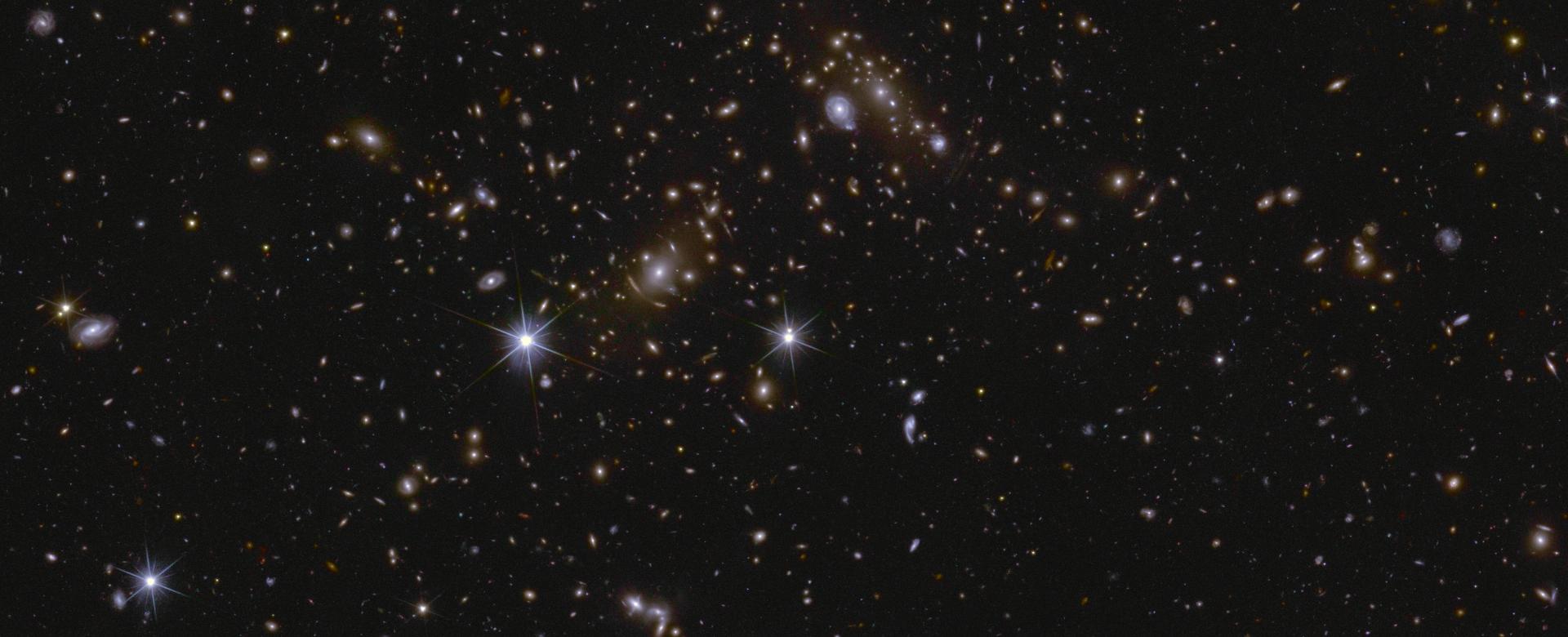 Image of an area of the Euclid Deep Field South showing several huge galactic clusters, as well as intracluster light and gravitational lensing. Image of an area of the Euclid Deep Field South showing several huge galactic clusters, as well as intracluster light and gravitational lensing.