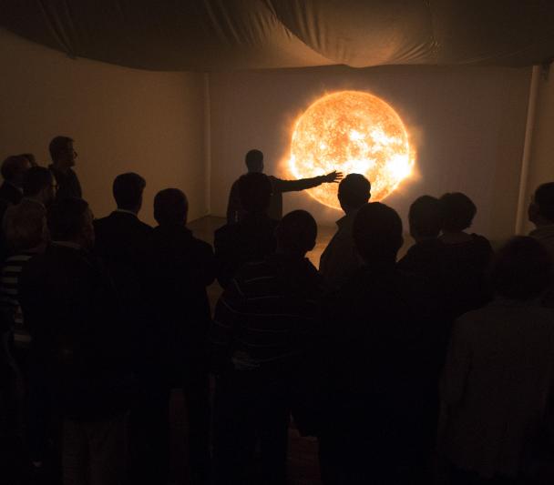 Visitors to the "Lights of the Universe" exhibition in front of the interactive module "Solar Immersion" on the upper floor of the Art Gallery of the Institute of the Canaries, Cabrera Pinto (La Laguna). Credits: Daniel López/IAC Visitors to the "Lights of the Universe" exhibition in front of the interactive module "Solar Immersion" on the upper floor of the Art Gallery of the Institute of the Canaries, Cabrera Pinto (La Laguna). Credits: Daniel López/IAC
