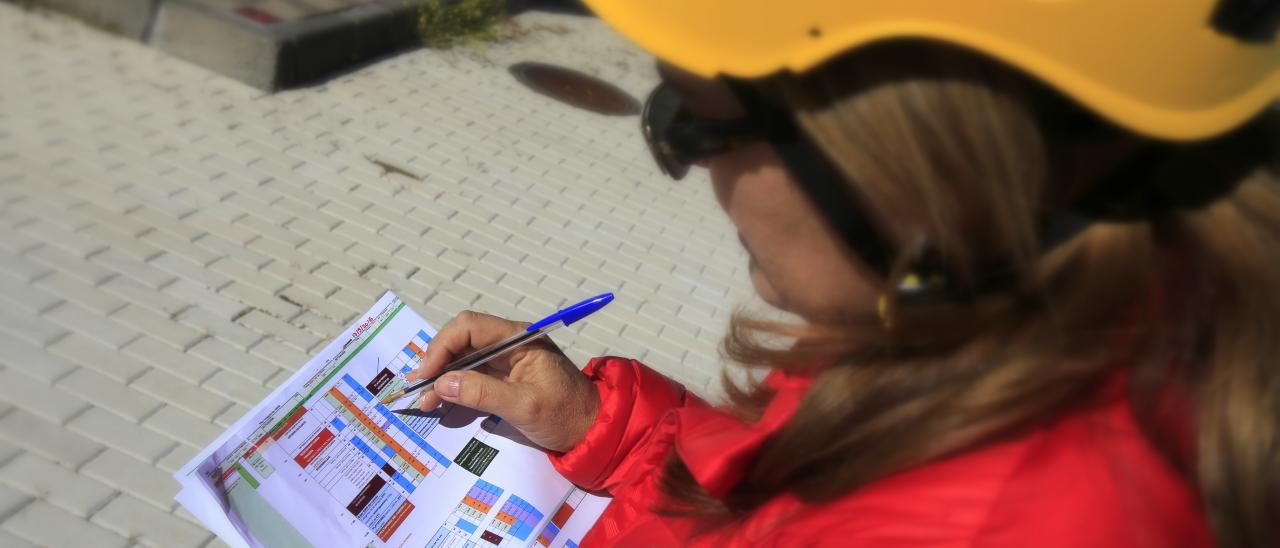 Engineer managing the installation phase of the EMIR instrument. Author D. López. View of a woman engineer reviewing some graphs on paper