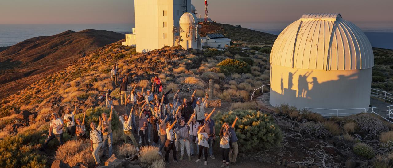 Attendees of the "Acércate al Cosmos" 2022 course at sunset with the solar towers