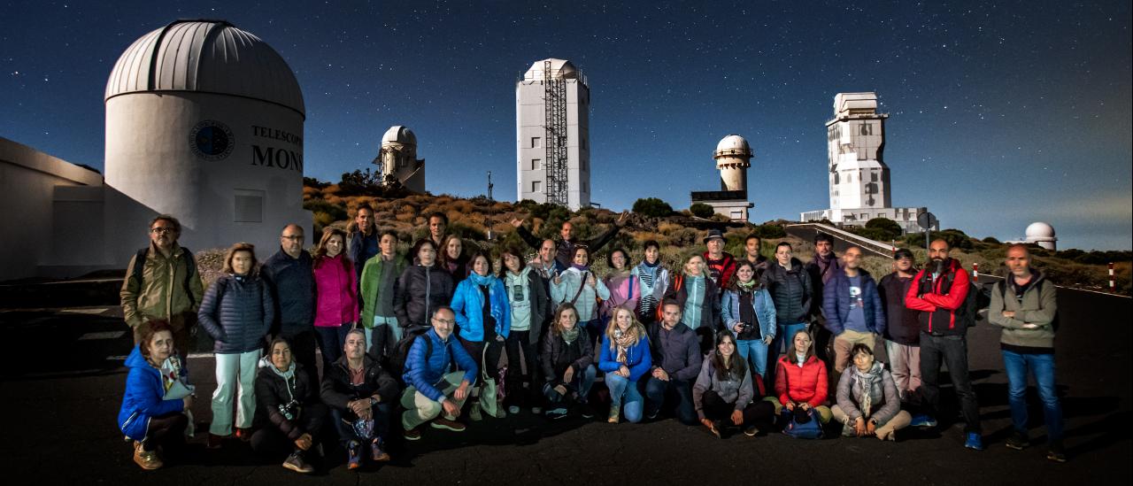 Teachers during night time observation with the solar towers at background