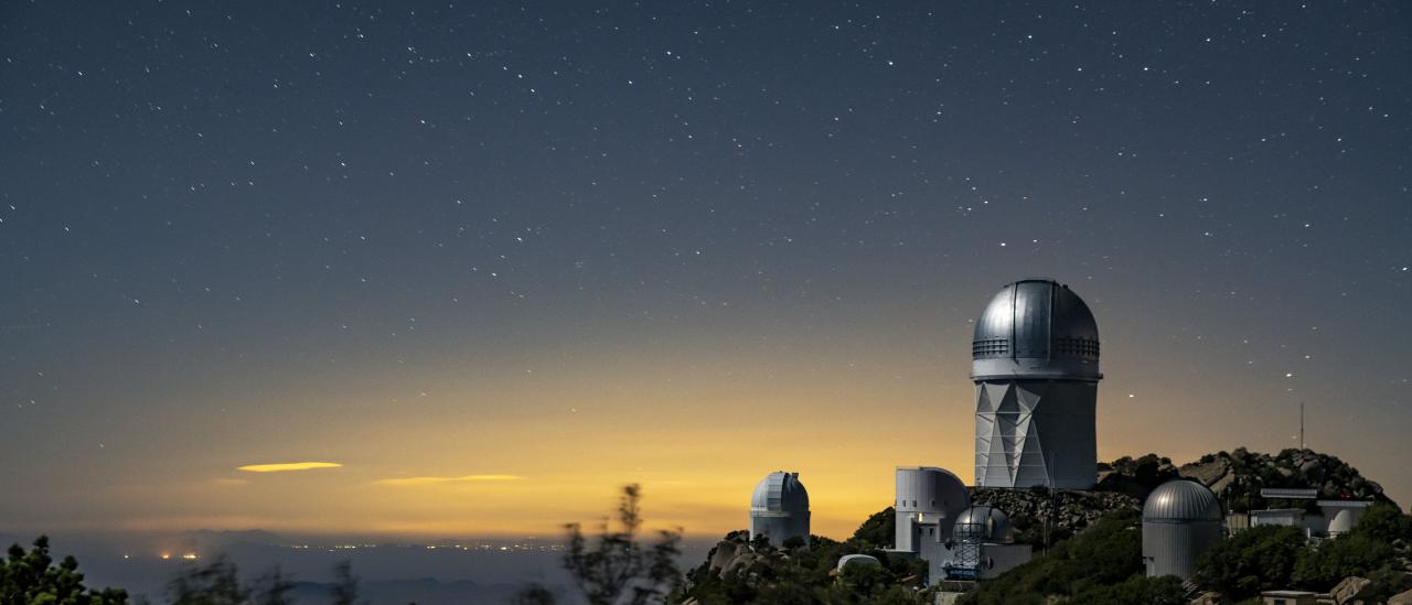 A view of the Mayall Telescope (tallest telescope at right) at Kitt Peak National Observatory near Tucson, Arizona. (Credit: Marilyn Chung/Berkeley Lab)