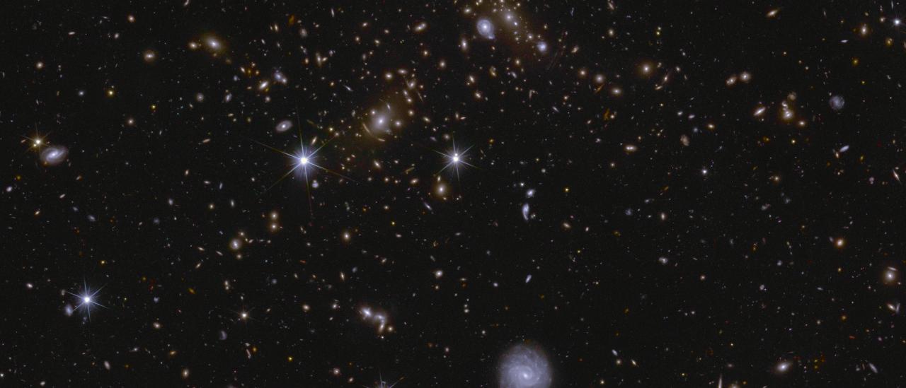 Image of an area of the Euclid Deep Field South showing several huge galactic clusters, as well as intracluster light and gravitational lensing.