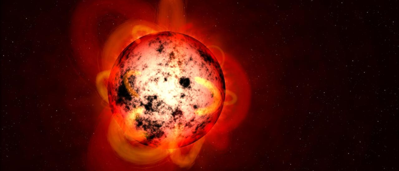 An illustration of an M-dwarf star covered in starspots.  NASA/ESA/STScI/G. Bacon.