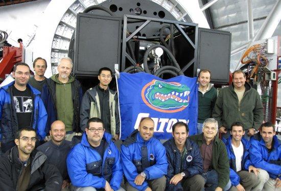 Some of the team responsible for the first installation and adjustment of CanariCam at the Gran Telescopio CANARIAS. The photograph shows the instrument installed at the Nasmyth focus, just above the "Gators" flag attached to the camera by University of F