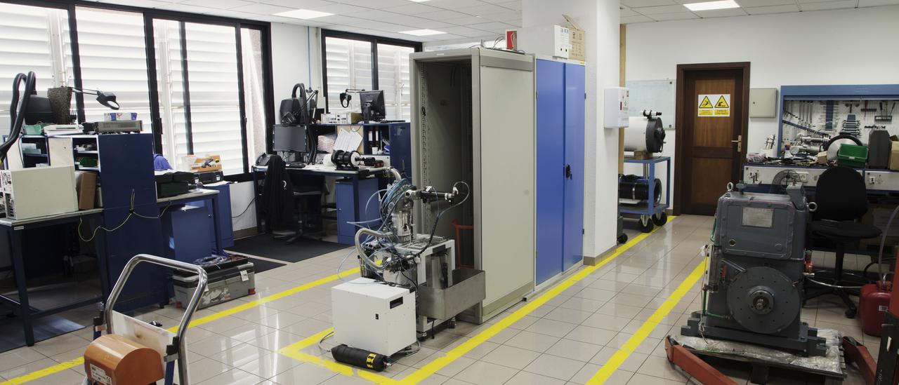 General view of the Instrument Maintenance Workshop with several work benches, cabinets and several machines under repair