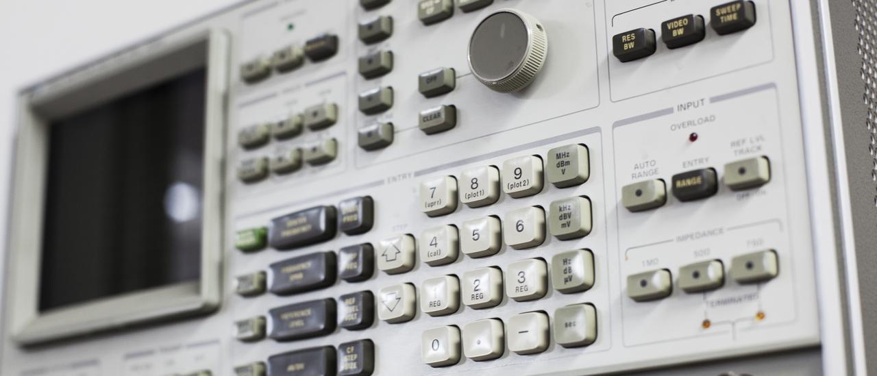 Front view of the spectrum analyser. Electronic device with a keyboard, buttons and a small screen