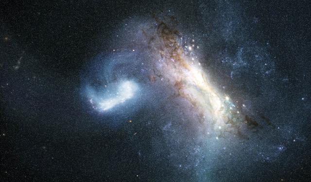An artist’s impression of the collision between a dwarf galaxy known as LKH (left) and a young Milky Way (right), some 12 billion years ago.