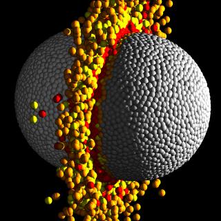 Esfera gris compuesta de pequeñas esferas, y rodeada de un anillo e esferas amarillas