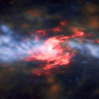 The galaxy’s central region has two distinct components: a spiraling, rotating disc (visible in red) consisting of cold molecular gas traced by carbon monoxide, and the outflowing gas, traced by ionised oxygen and hydrogen (in blue-orange hues) perpendicular to the inner nuclear disc. Credit: ESO/A. Alonso-Herrero et al.; ALMA (ESO/NAOJ/NRAO) Combined ALMA and VLT/MUSE data of the Seyfert galaxy NGC 5643.