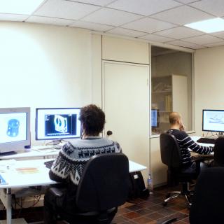 Panoramic view of the CAD studio with engineers at work stations Panoramic view of the CAD studio with engineers working with desktop computers